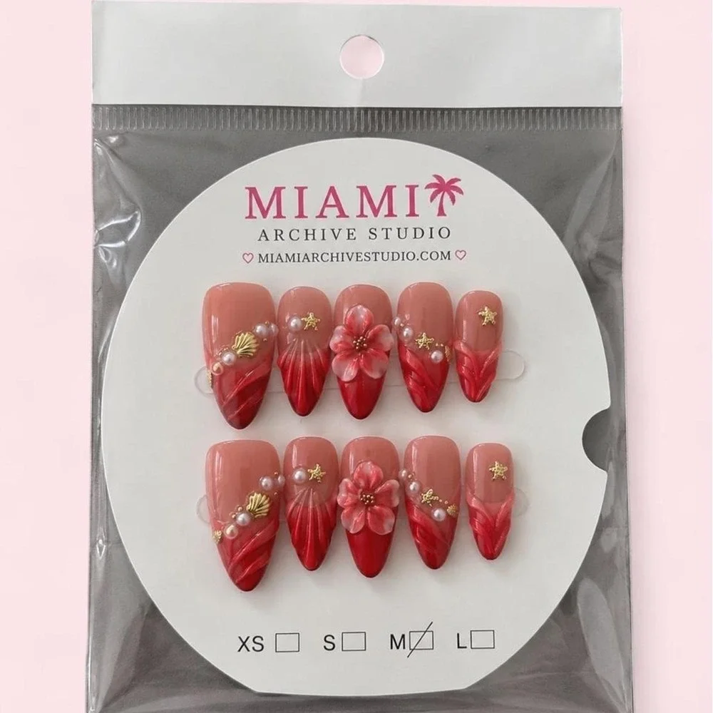 red and pink floral press-on nails with gold stars and pearls